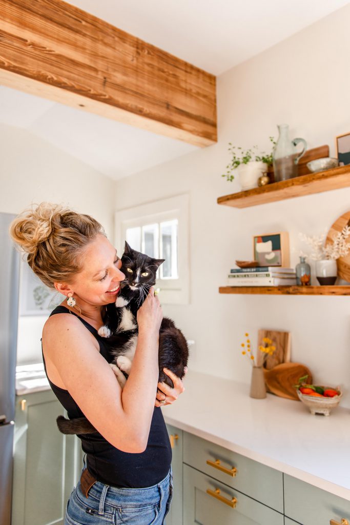 amanda paa in her kitchen with her cat.