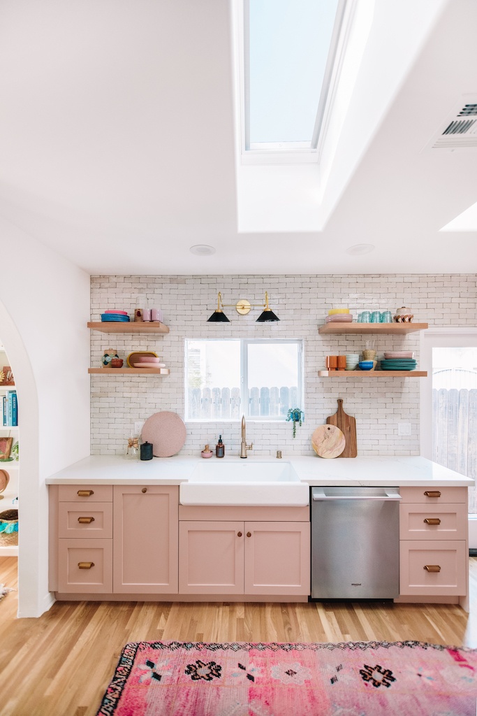 view of kitchen with open cabinetry and pink cabinets.