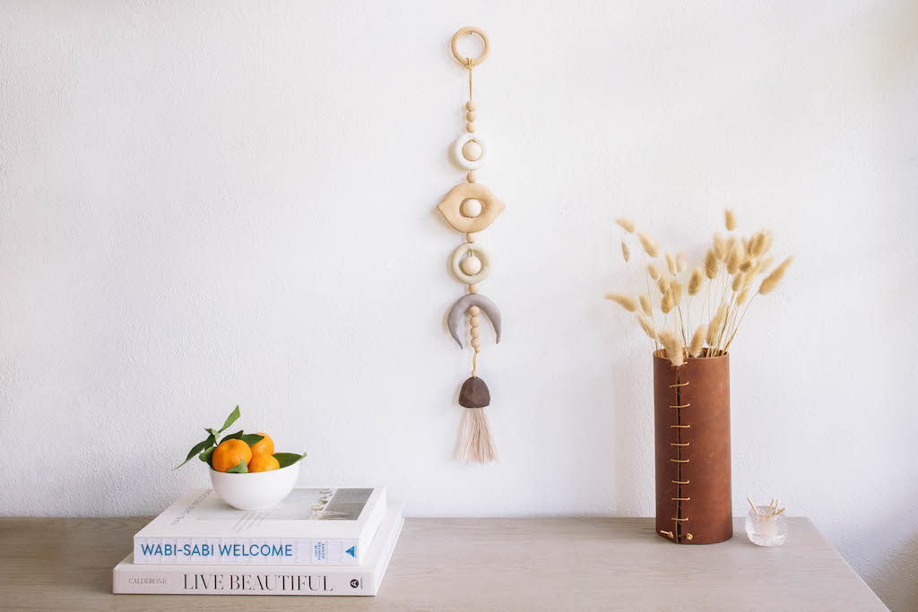 lunar wall hanging above a table with books