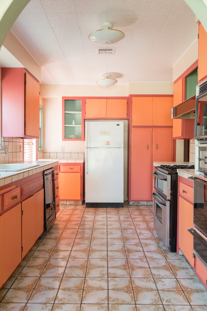 the original kitchen had orange, green, and red cabinetry.