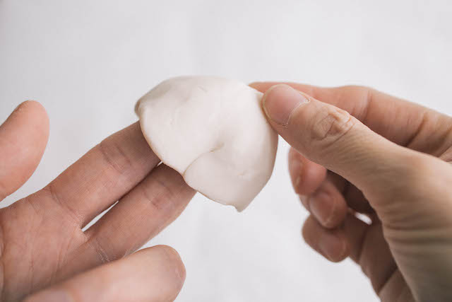 Roll clay into a flat circle that’s about three to four inches in diameter.