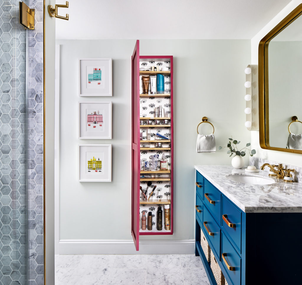 a bathroom with a blue vanity and a pink medicine cabinet