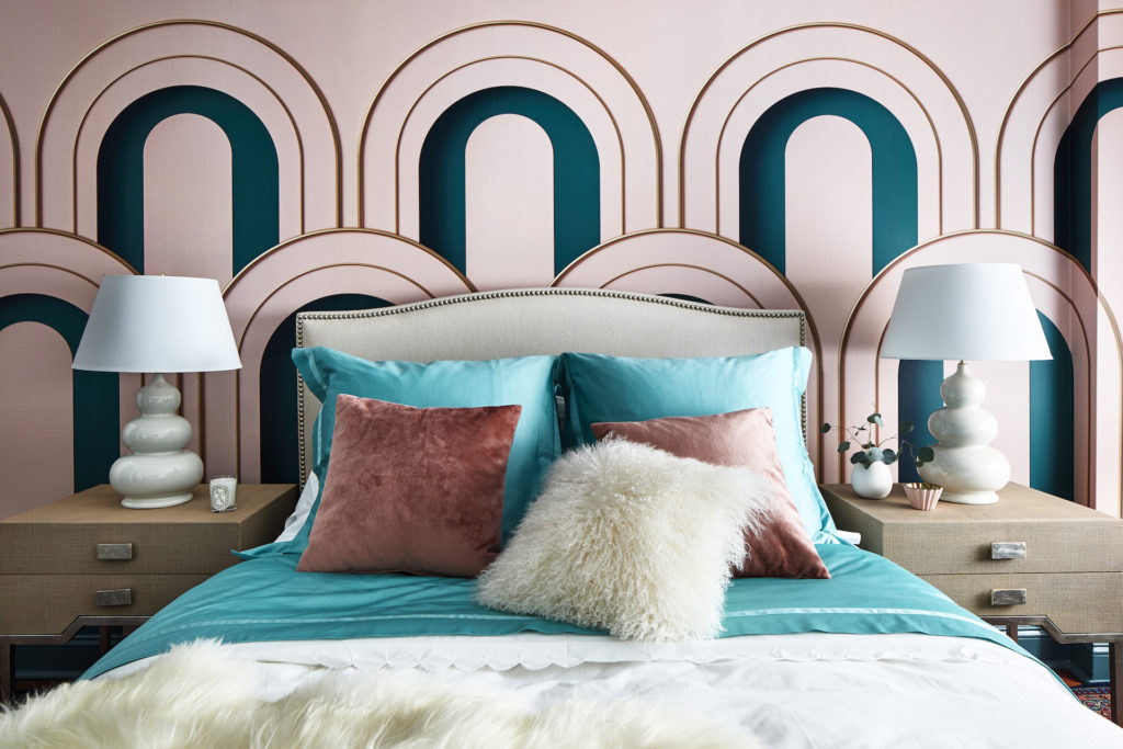 the bedroom with a pink and blue curved wall treatment above the bed