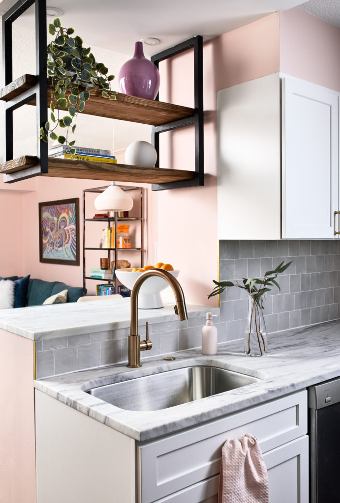 kitchen sink with open shelving overhead, separating the kitchen from the dining nook