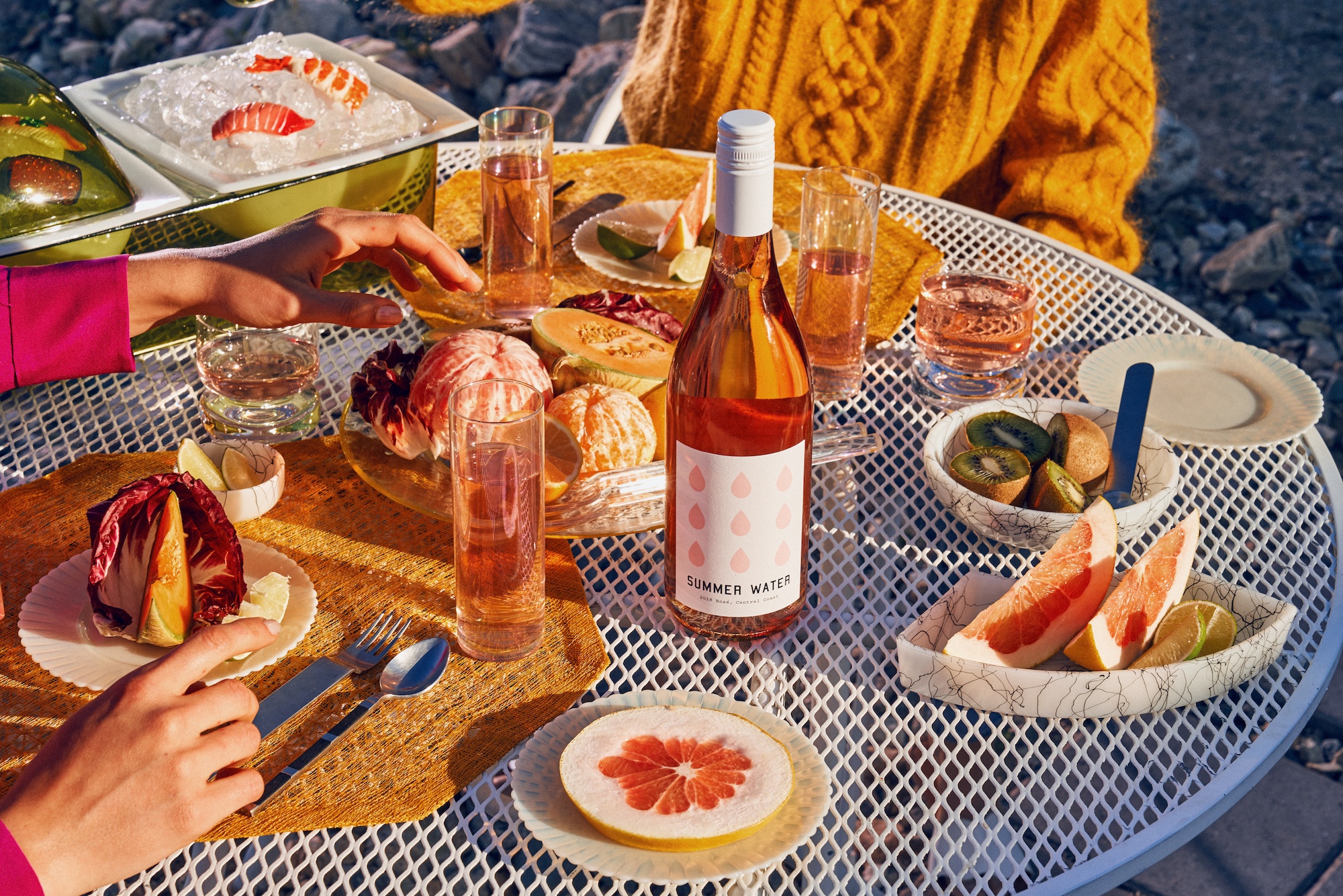 a table covered in food and rose bottles