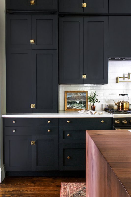 wall of black cabinetry with gold fixtures