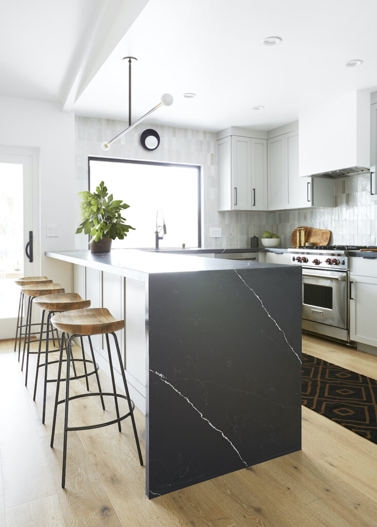 Light gray kitchen with dark marble island