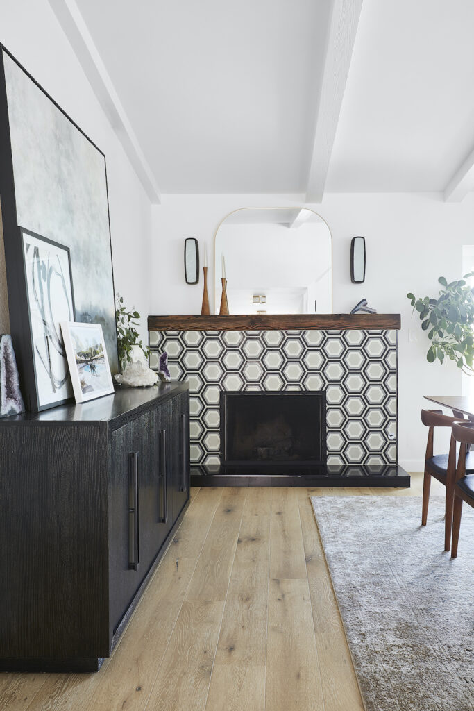 Fireplace covered in black and white graphic tile