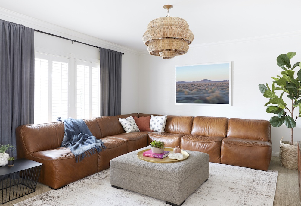 Living room with white walls and brown leather sectional