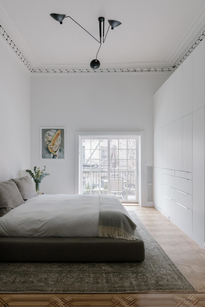 White bedroom with wall of closets