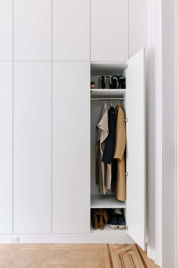 Wall of closets with one door open