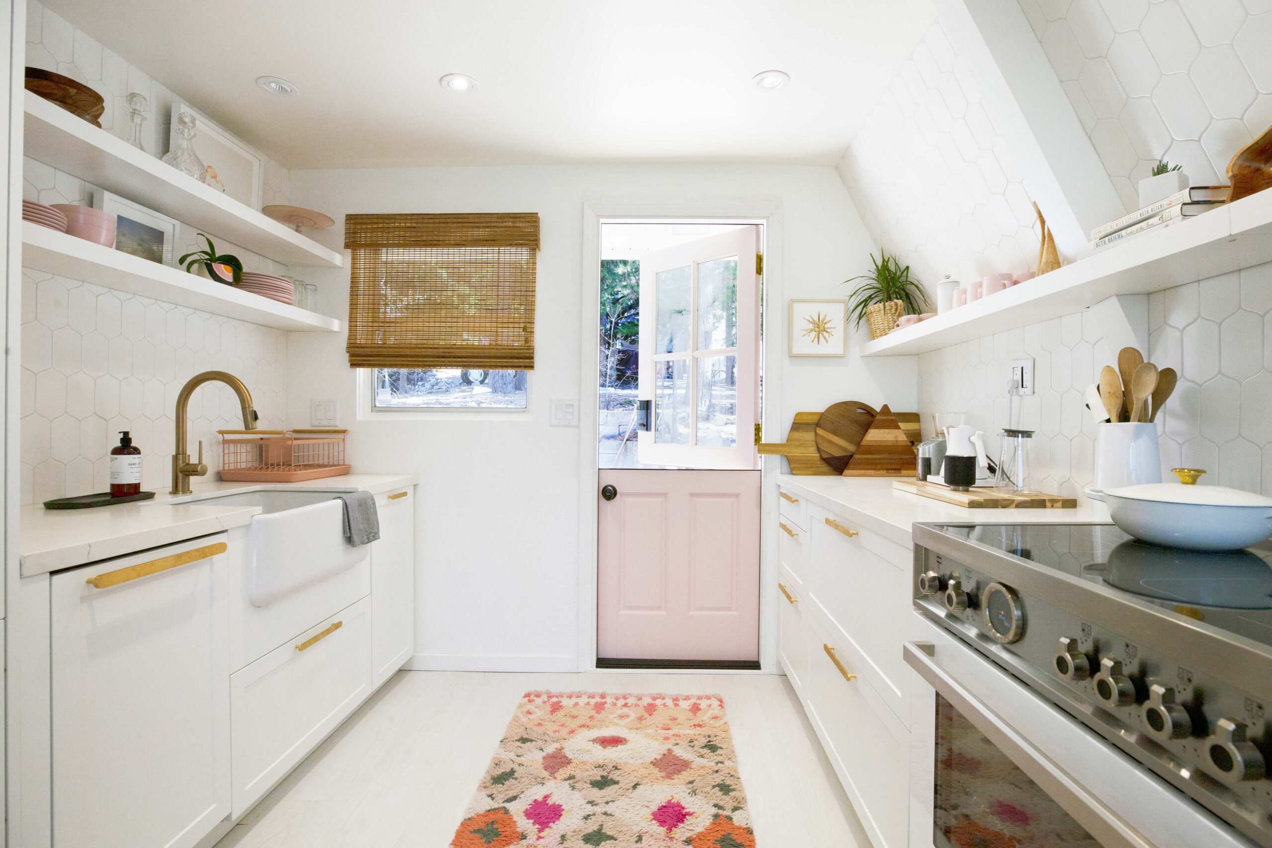 White kitchen with pink door