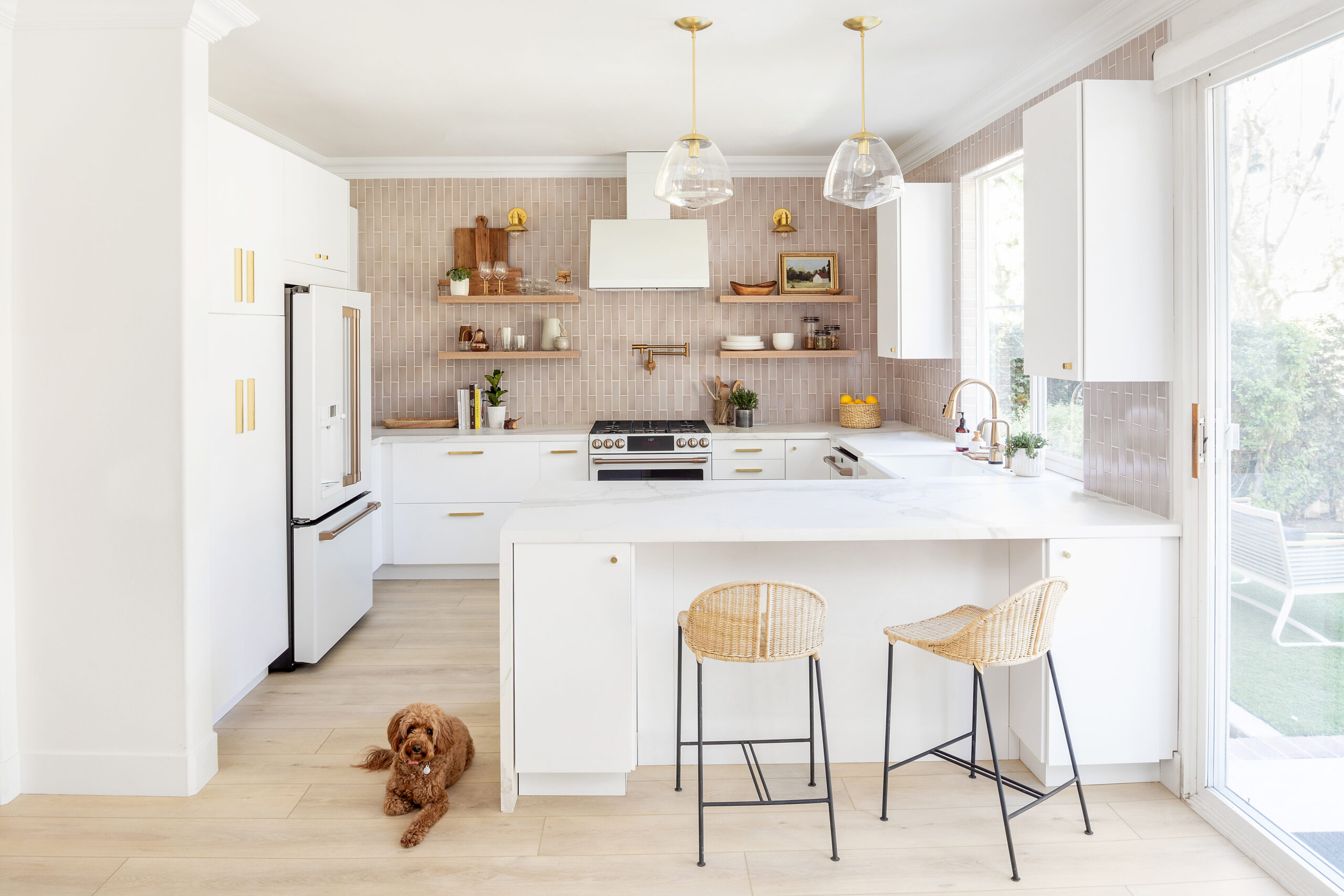 White cabinets and pink tile in a kitchen