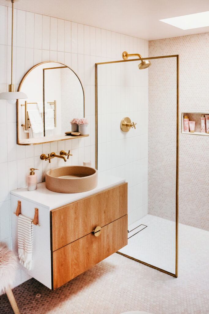 Wood bathroom vanity in a pink space