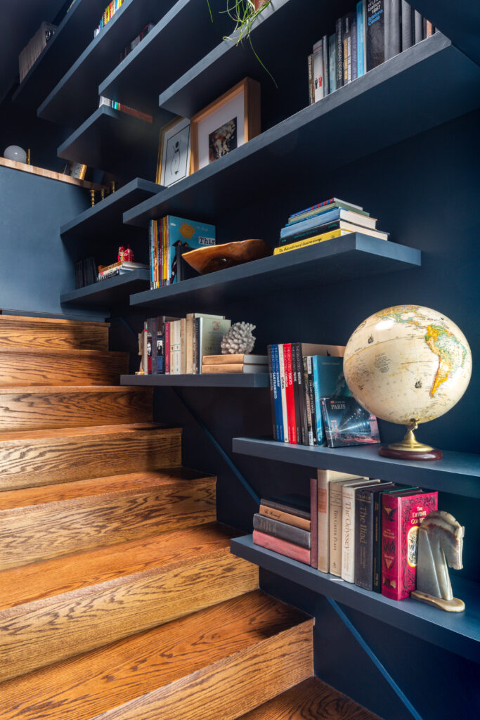 Blue bookshelves lining a staircase