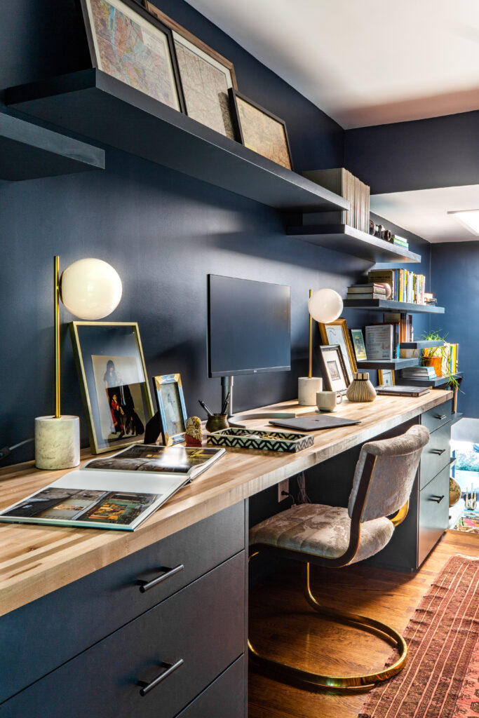 Long desk in a blue painted office