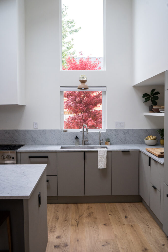white and gray kitchen with long window