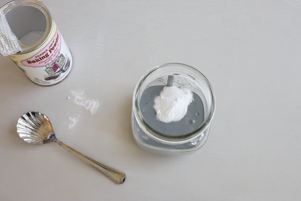 Baking powder added to a cup with gray paint