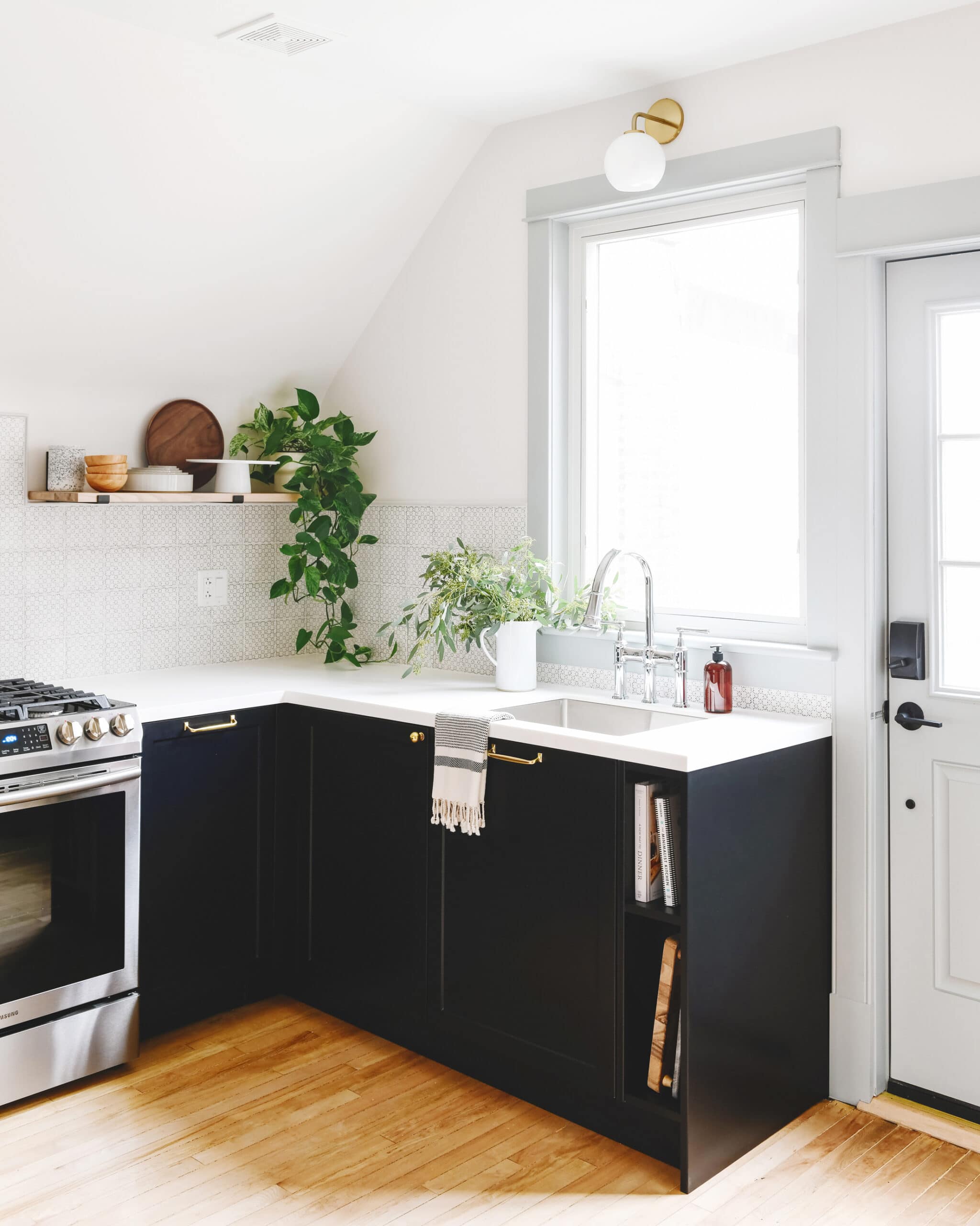 Black lower cabinets in a white kitchen