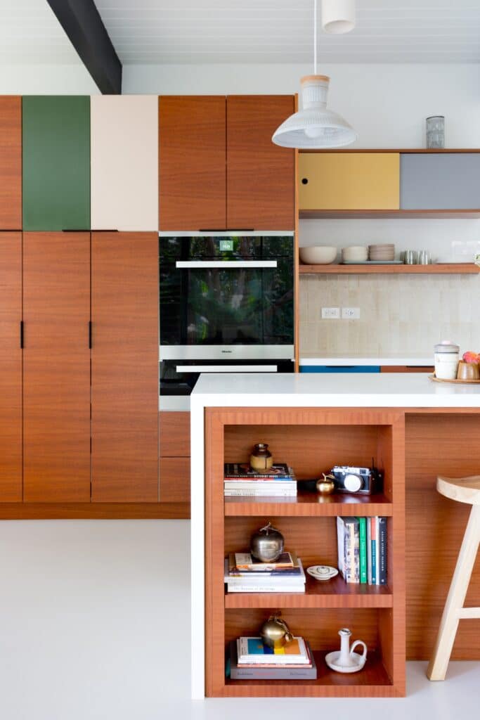 Cherry kitchen cabinets with color block and storage details