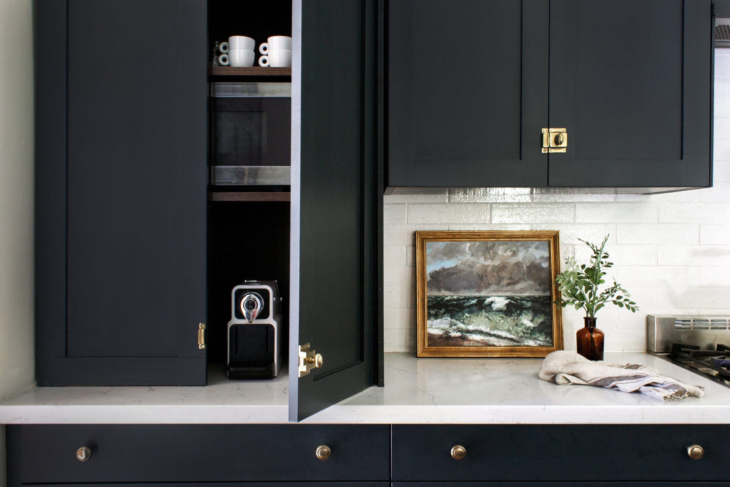 Black kitchen with appliance garage