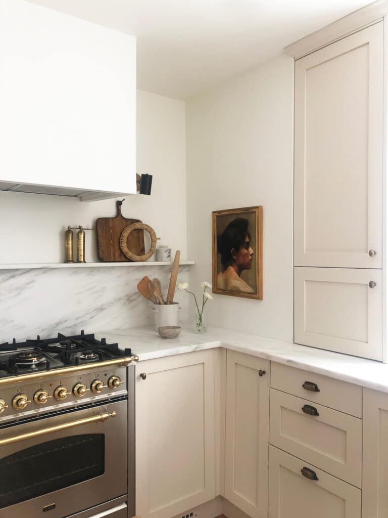 Cream kitchen corner with shelf and vintage art
