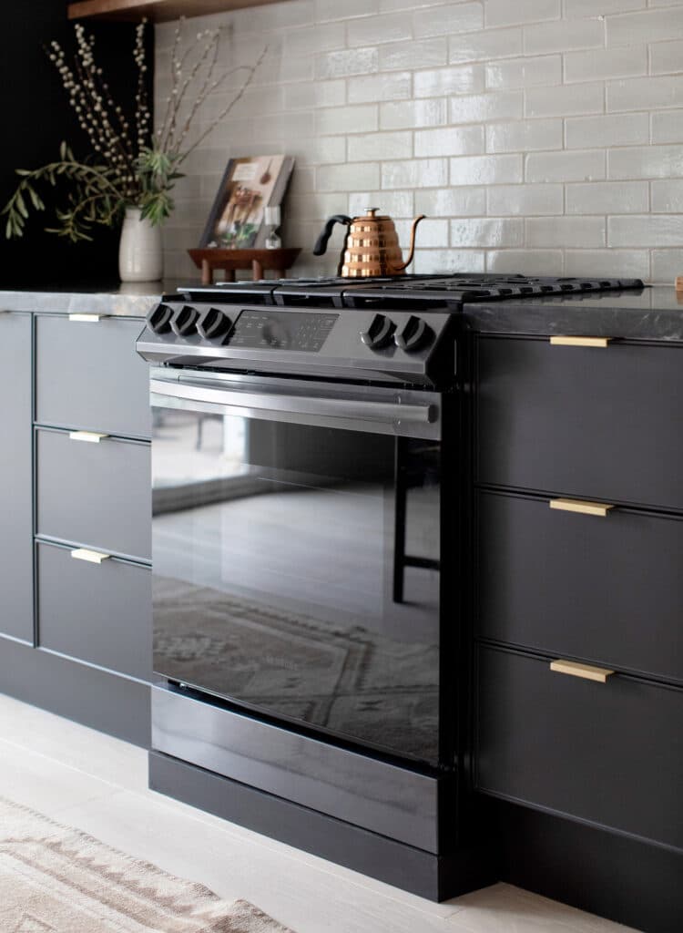 Black stove with black cabinets in the kitchen