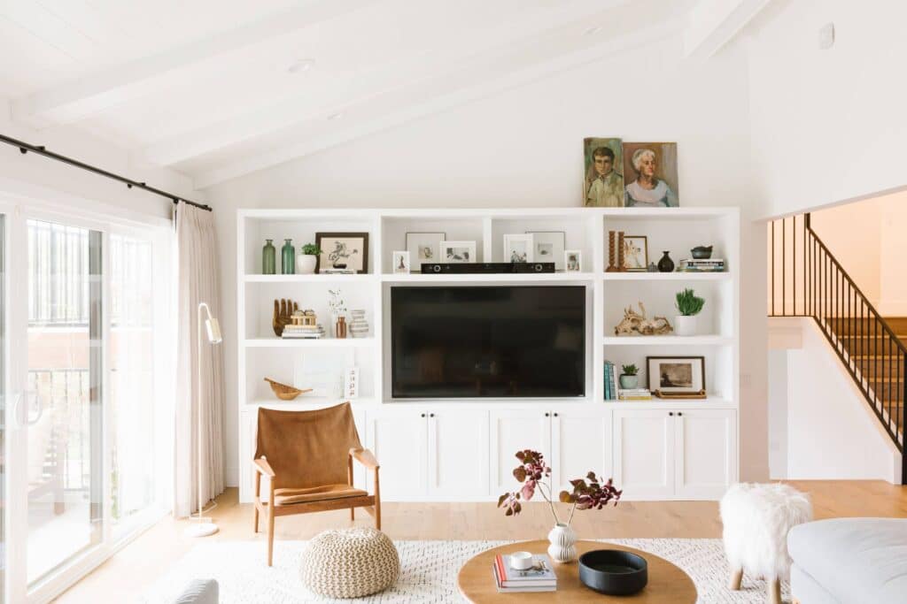 White living room with floor to ceiling built in storage