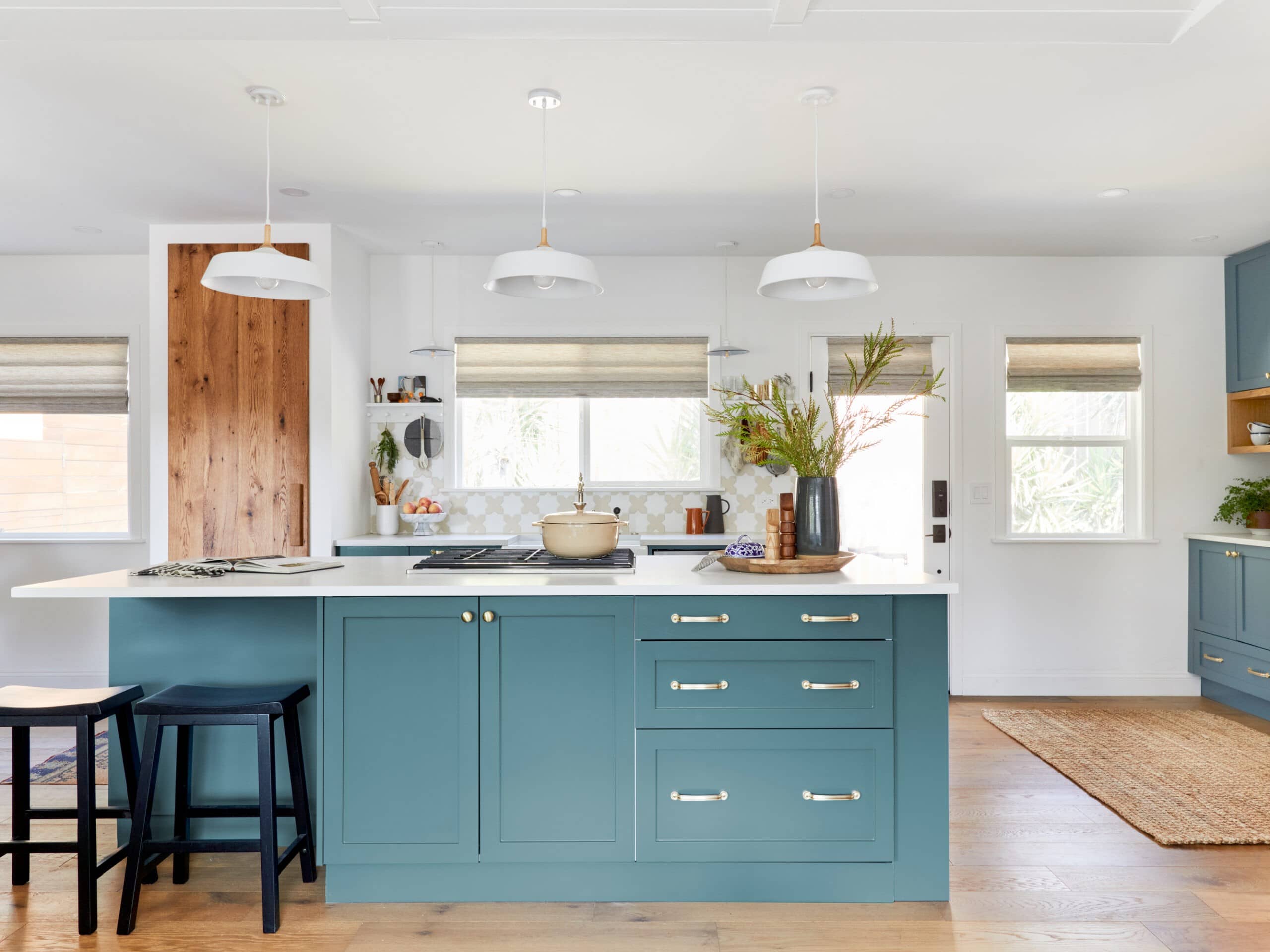 Blue green kitchen island with white accents