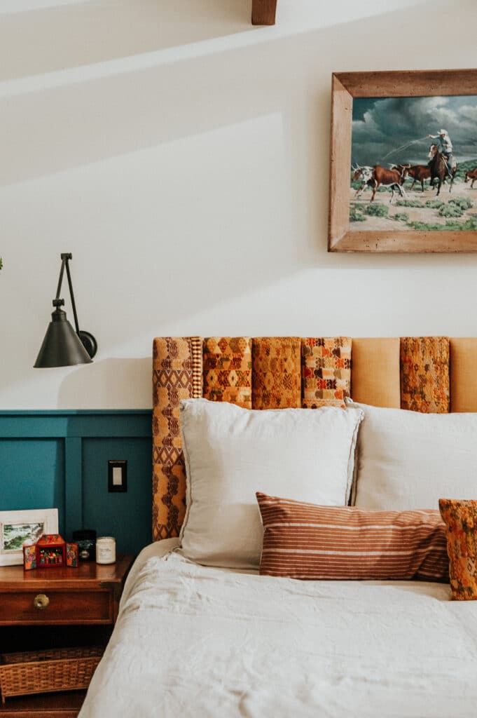 Bohemian bedroom details with blue walls and copper headboard
