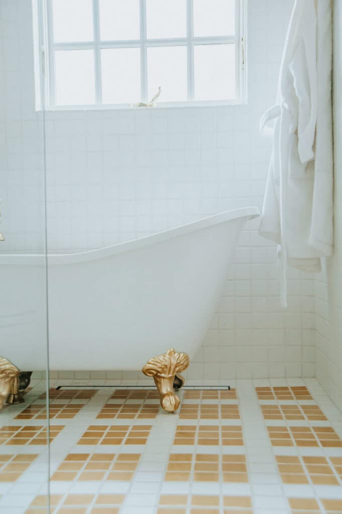 Patterned white and yellow tan tile bathroom floor
