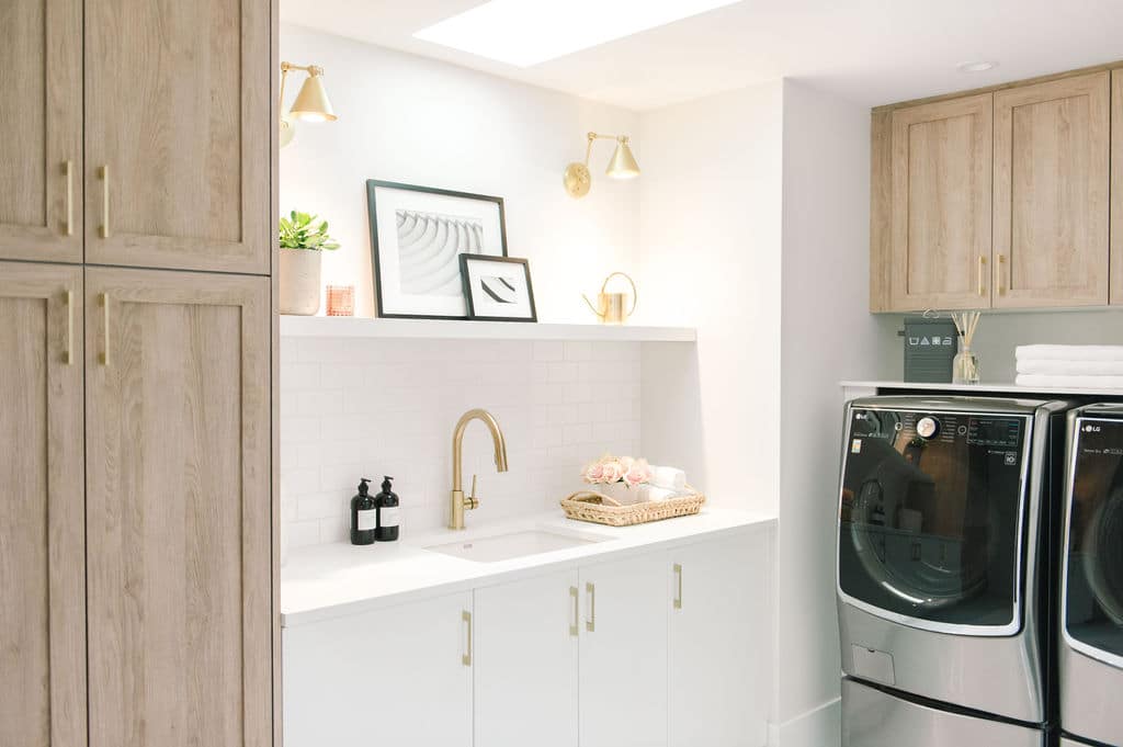 White and wood cabinets in a laundry room